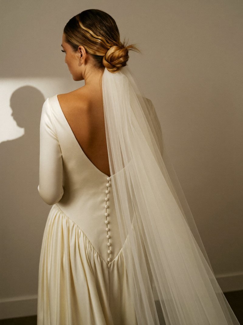 Bride with a soft low bun and a long veil attached below it