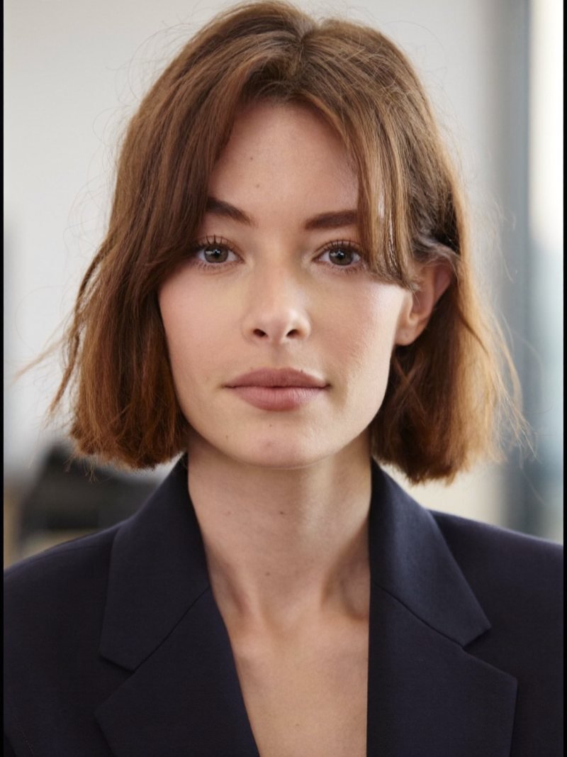 Chin-length auburn bob with curtain bangs