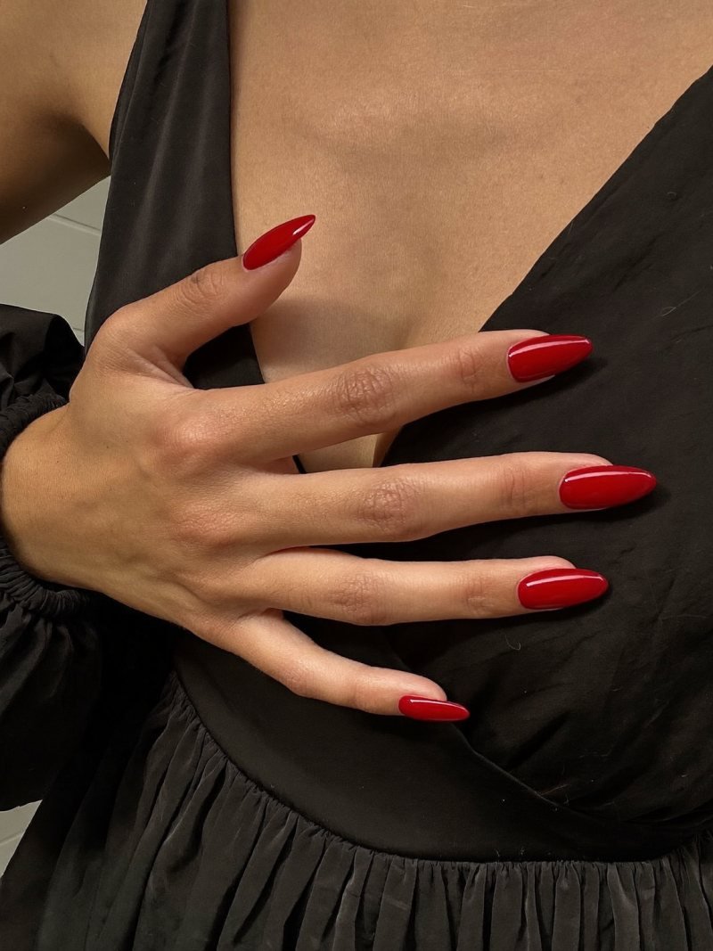 Classic red nails for a black dress, short almond shape