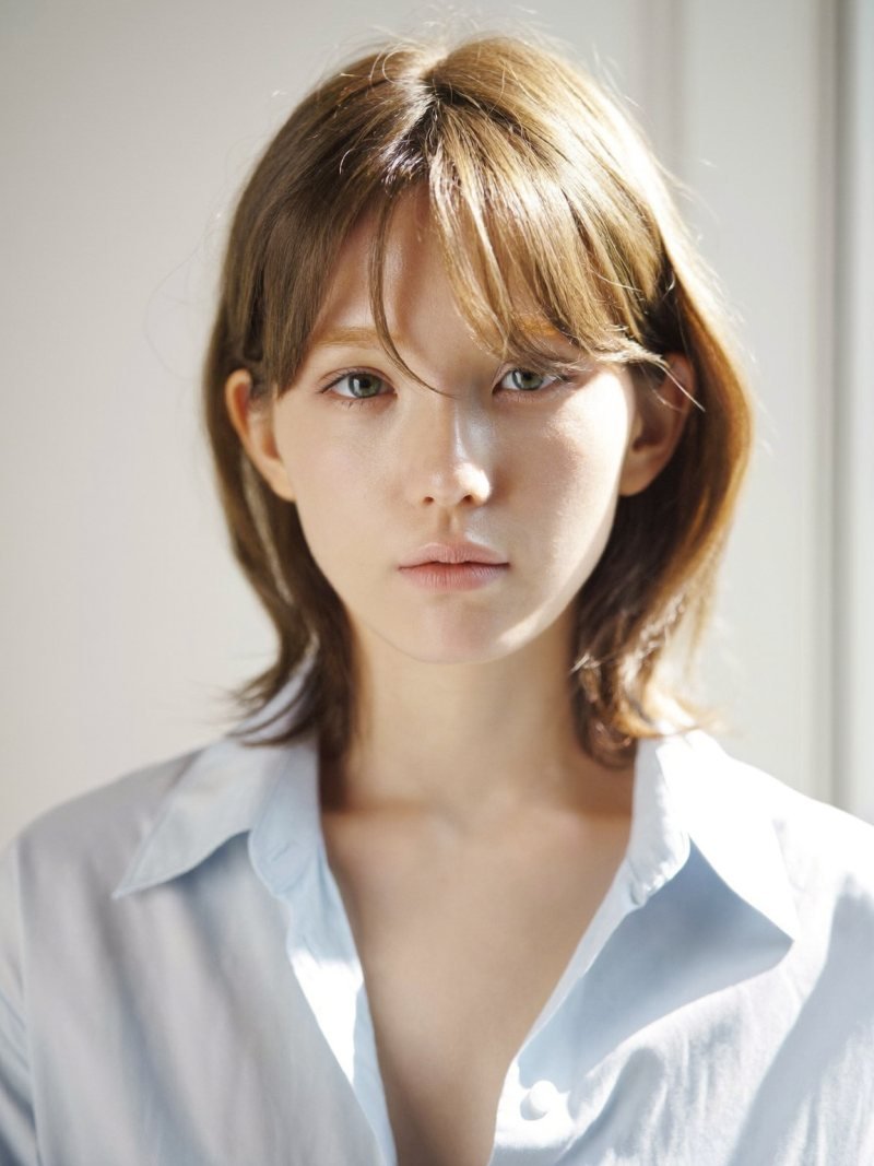 Fine light brown hair with thin wispy curtain bangs