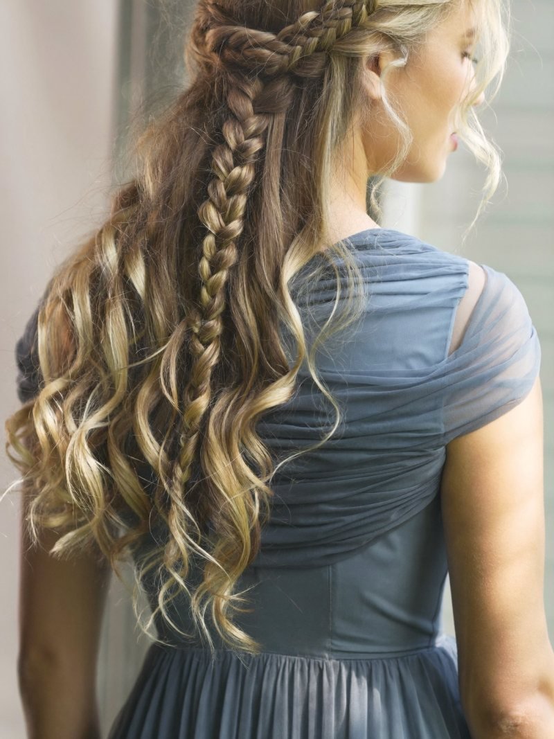 Long blonde curls with a waterfall braid across the back