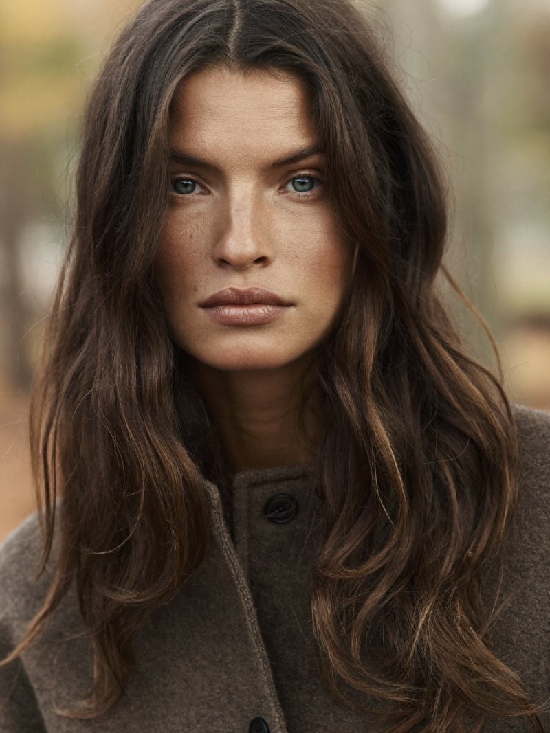 Long dark blonde hair with face-framing layers around the cheekbones