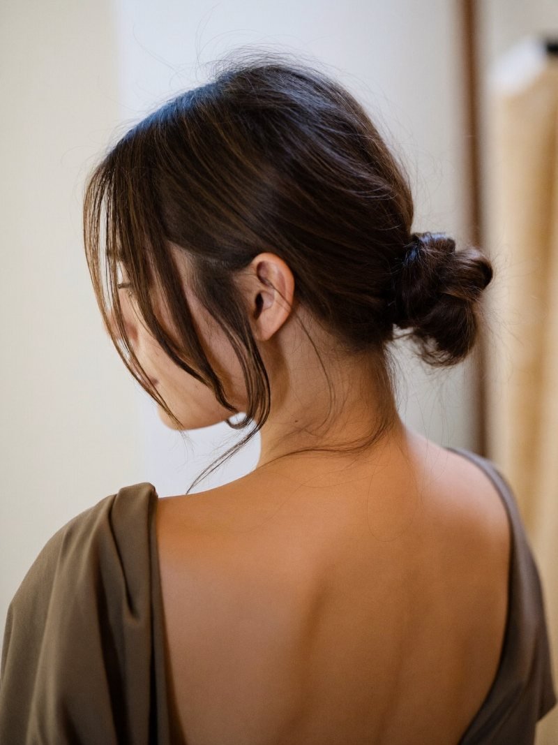 Long hair in a low textured bun