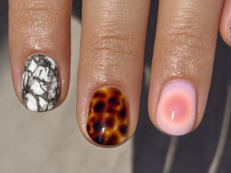 Marble, tortoiseshell and aura nail designs side by side
