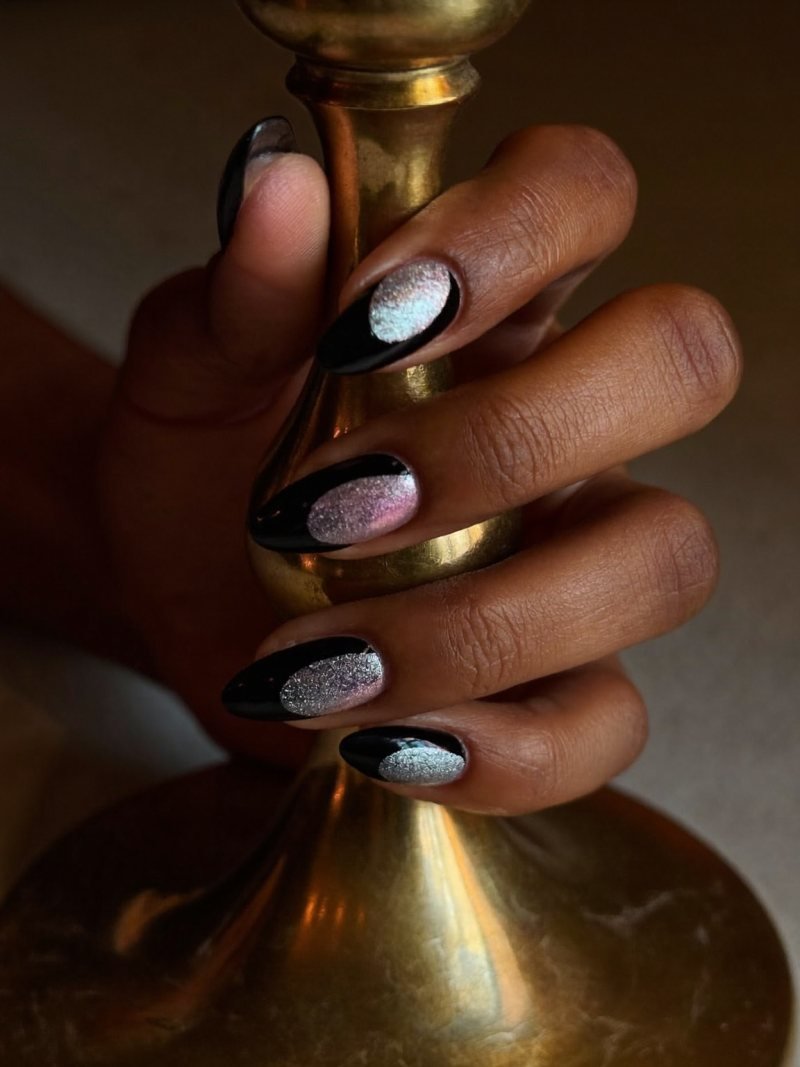 Medium almond black nails with a silver magnetic cat eye shimmer
