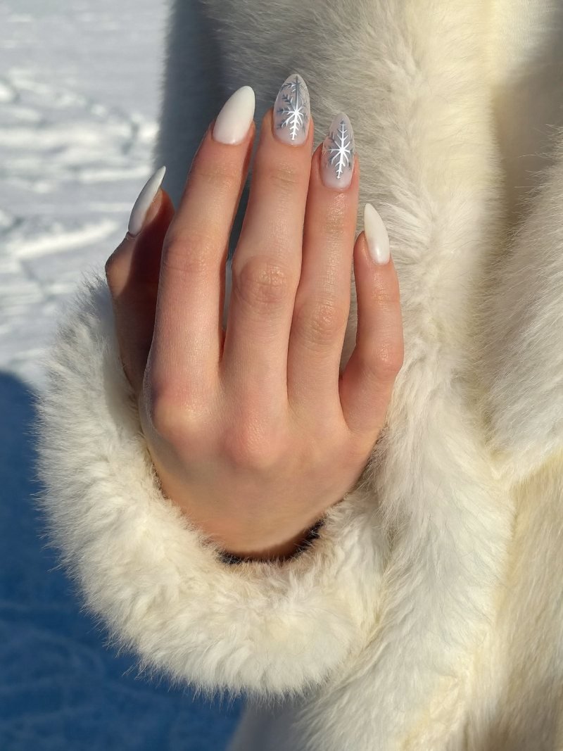 Medium almond milky nails with one delicate snowflake accent