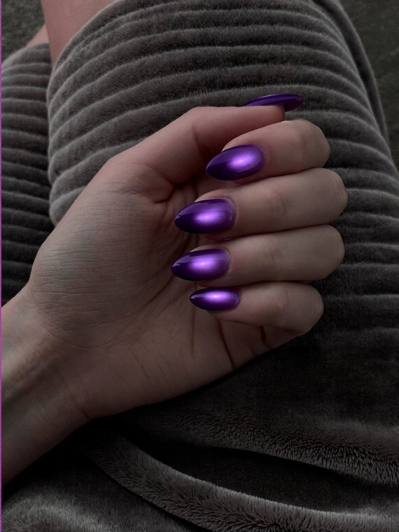 Medium almond nails in deep purple with a soft lilac glow in the center