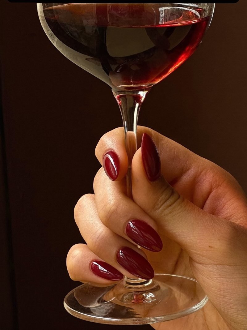 Medium almond nails in glossy dark blood red