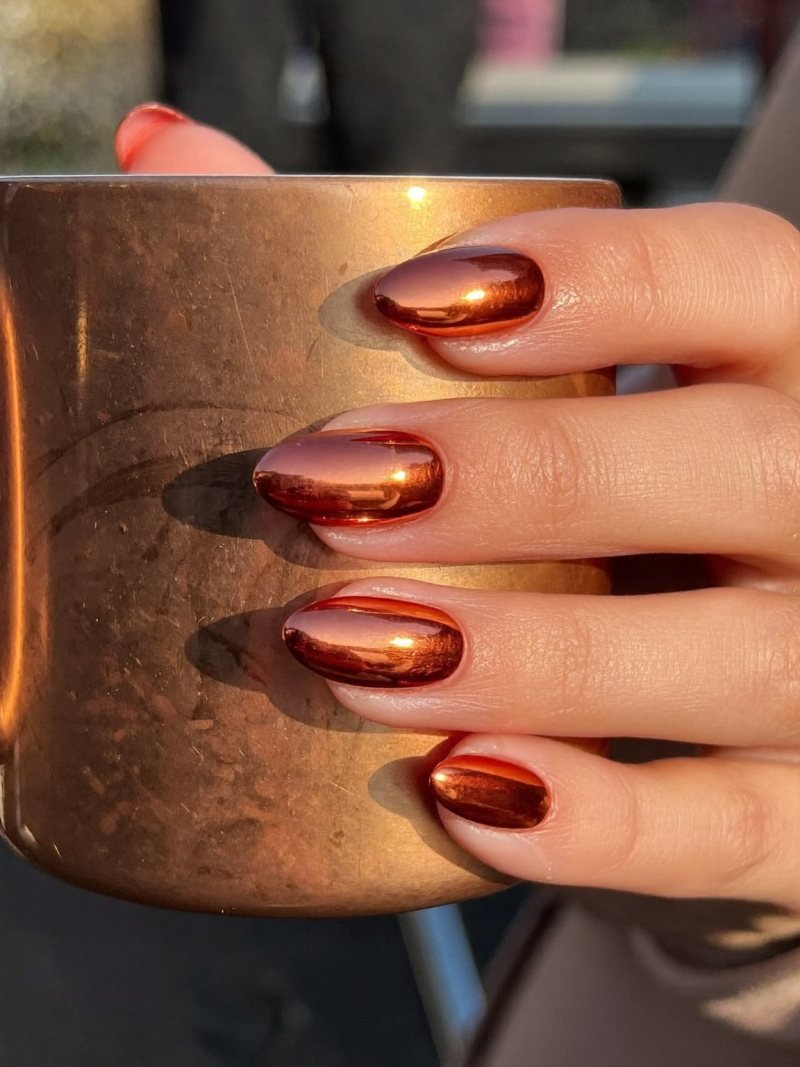 Medium almond nails with a copper chrome finish