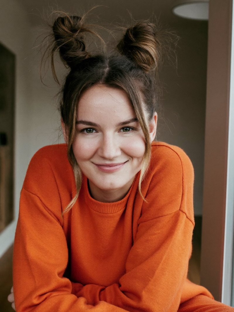 Medium brown hair in two high space buns with loose face-framing pieces