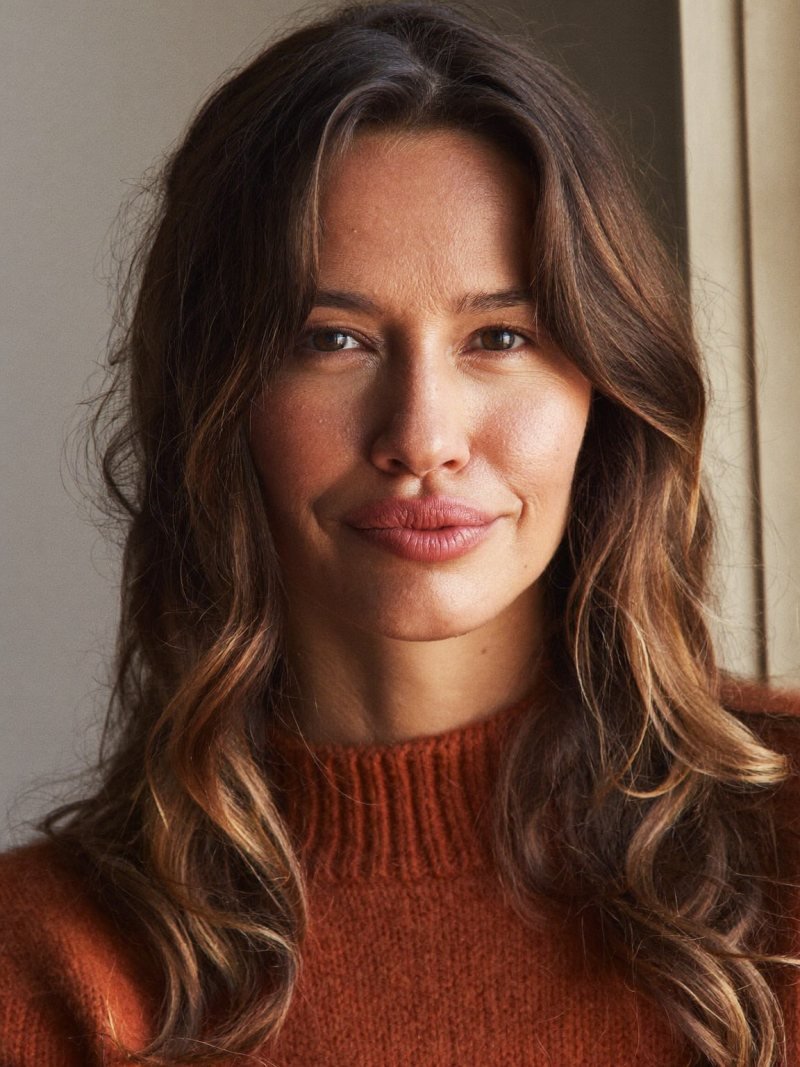 Medium brown hair with soft curtain bangs parted in the center