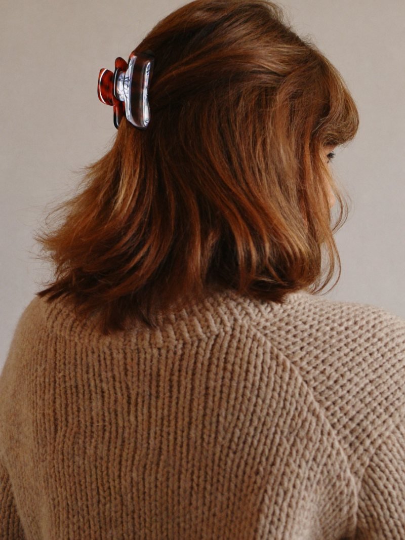 Medium hair worn half up with a tortoiseshell claw clip