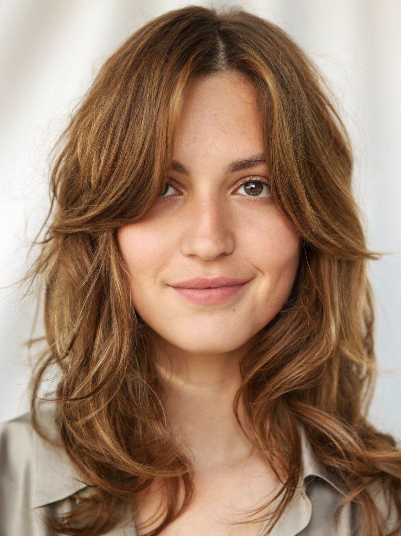 Medium layered hair with curtain bangs