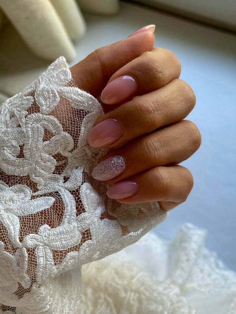 Medium oval sheer nails with fine white lace art on two nails