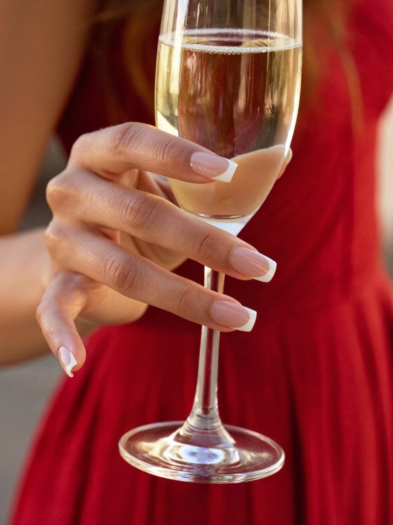 Medium square French manicure with a red dress
