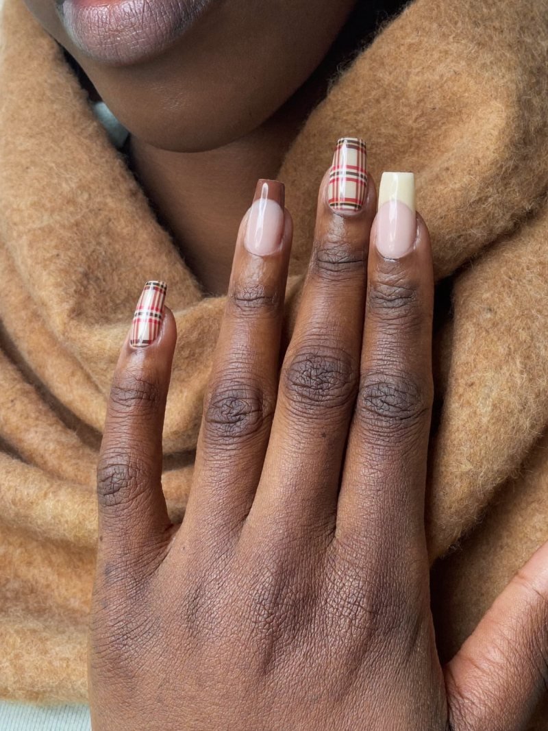 Medium square nude nails with brown and red plaid on two fingers