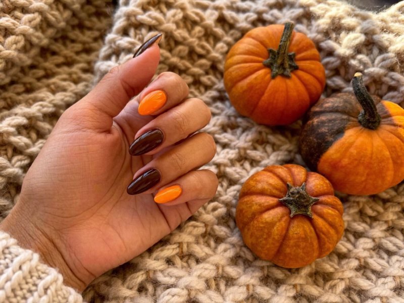 October nail ideas shown on short almond nails in pumpkin orange and chocolate brown