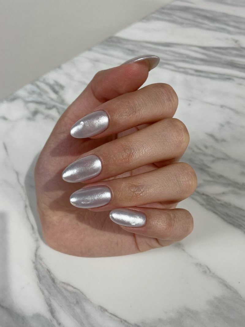 Short almond gel nails with a sheer pearly glazed finish