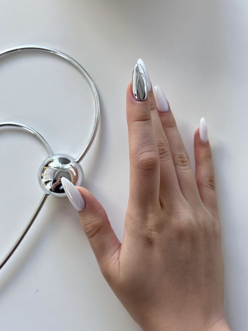 Short almond milky nails with one silver chrome accent nail
