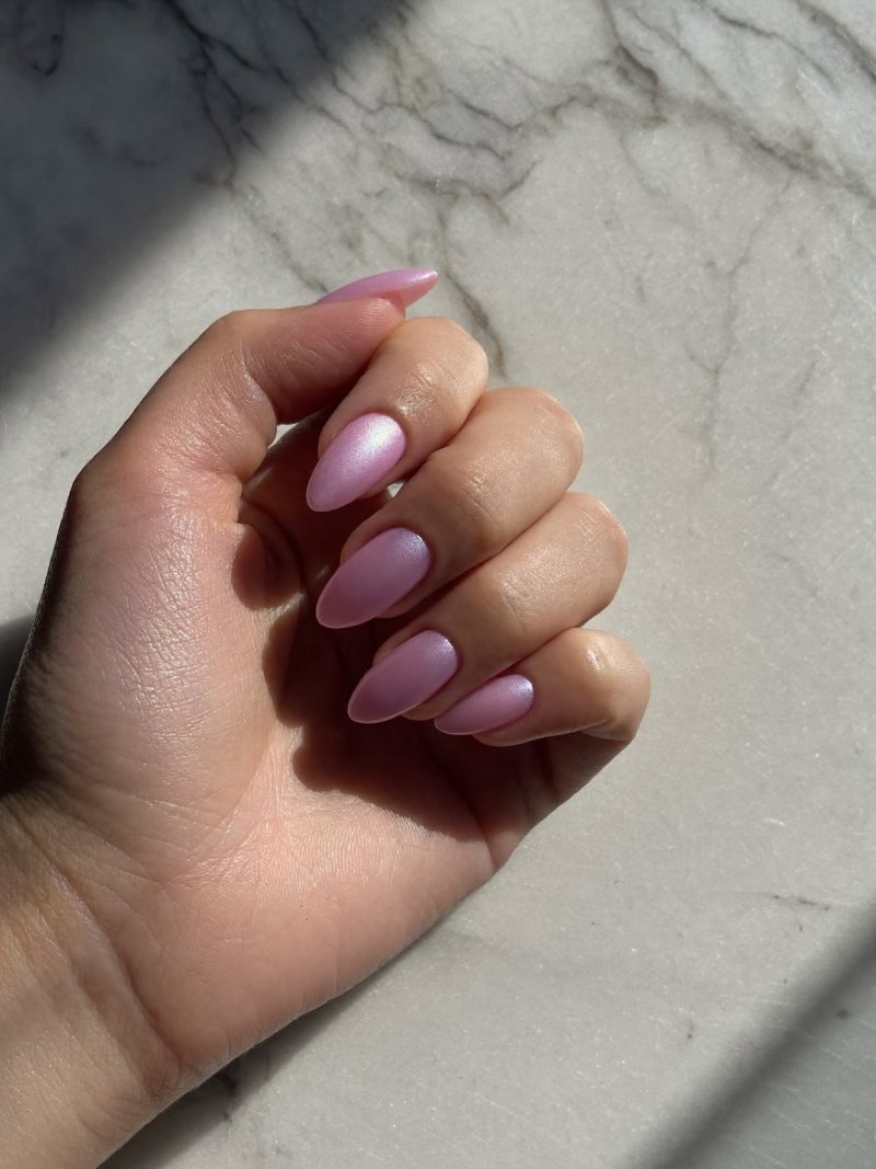 Short almond nails in sheer pink with a pearly glaze