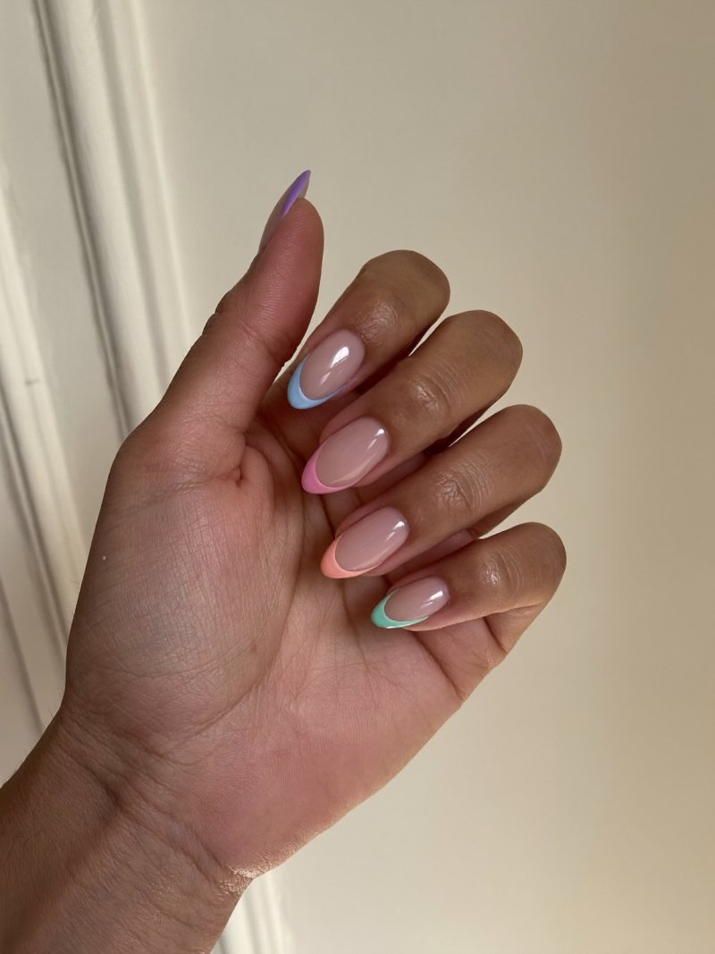 Short almond nails with a different pastel French tip on each nail