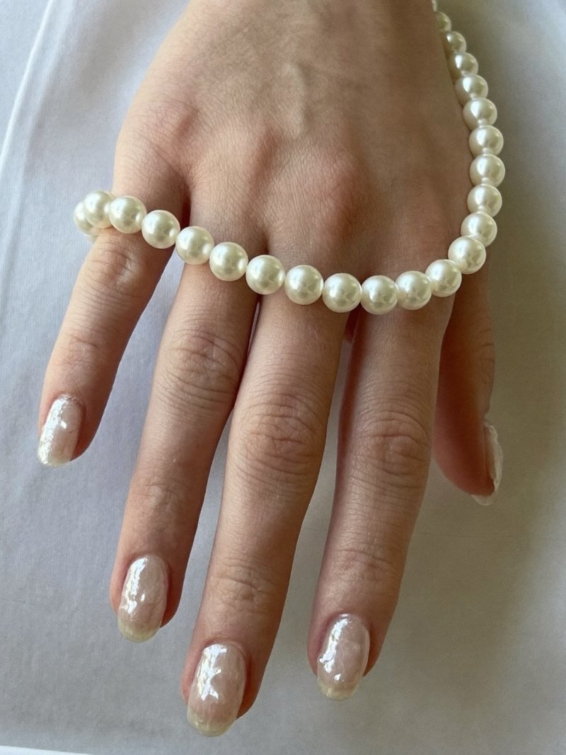 Short almond nails with a sheer pearl glaze
