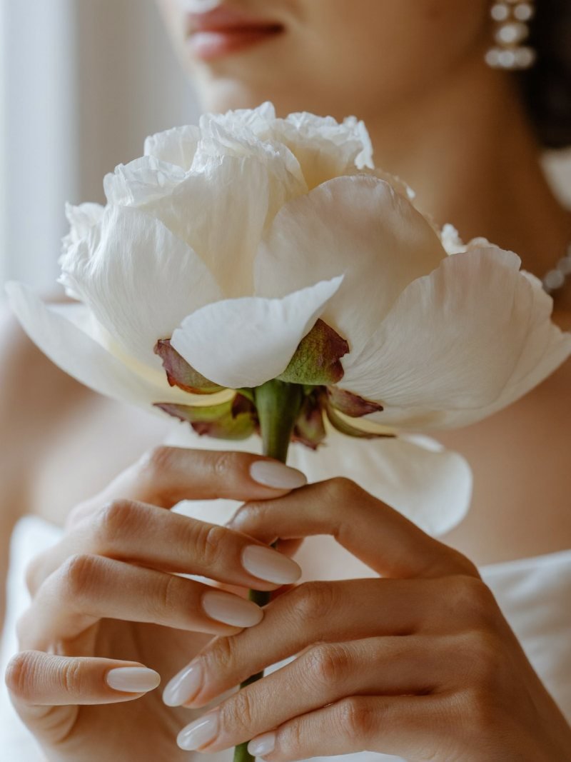 Short oval milky white nails for a bride