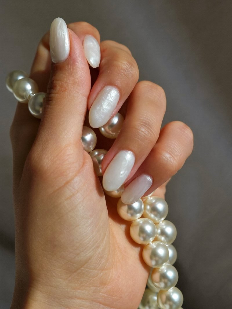 Short oval milky white nails with pearl chrome