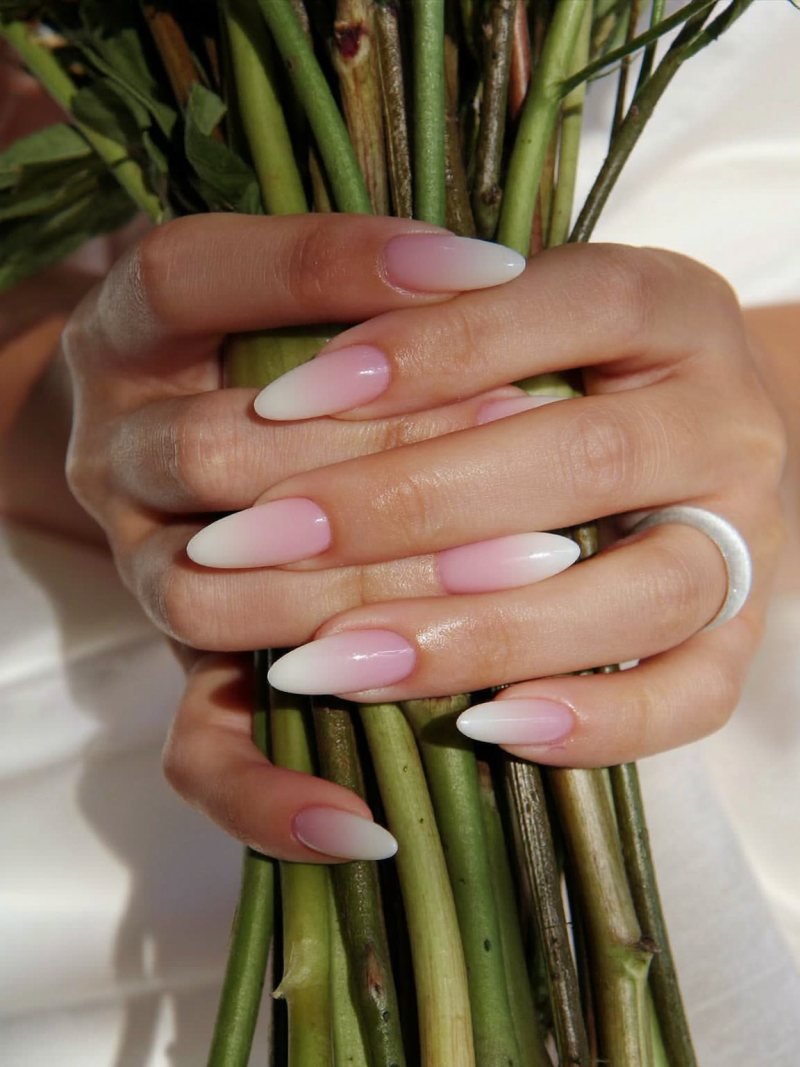 Short oval nails with a soft pink to white ombre