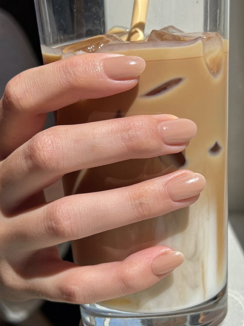 Short round nails in a sheer milky latte nude