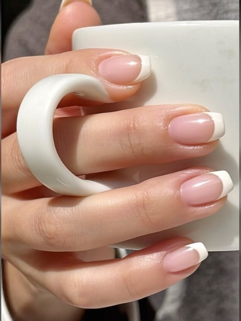 Short square gel nails with a very thin white French tip