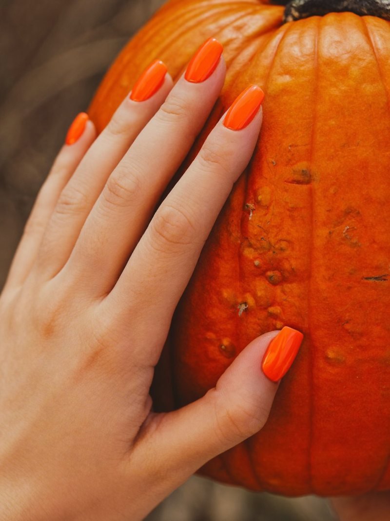 Short square nails in glossy pumpkin orange