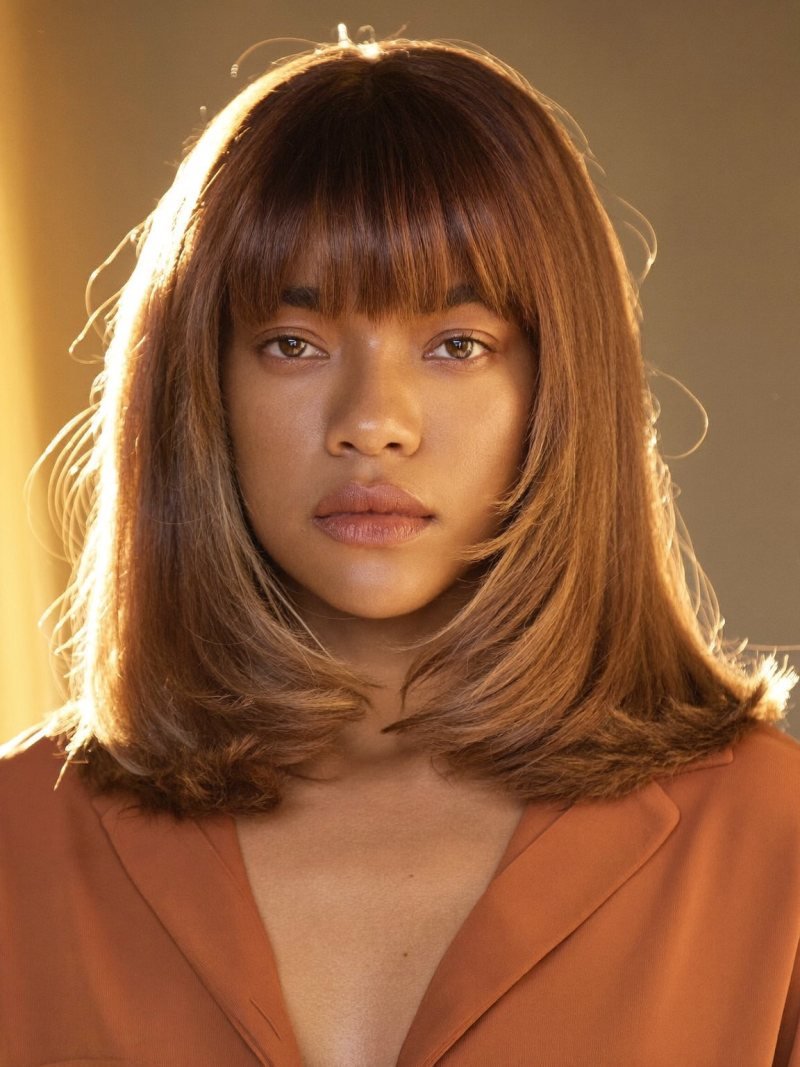 Shoulder-length caramel hair with bottleneck bangs