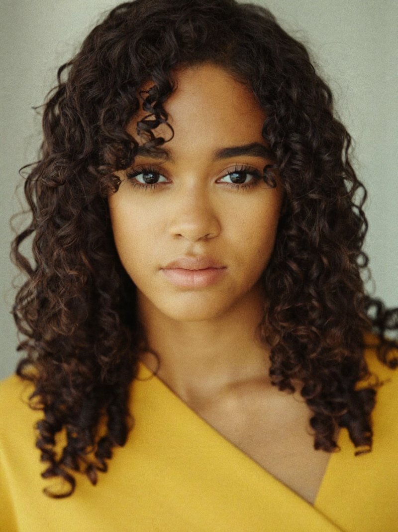 Shoulder-length dark curly hair with curly curtain bangs
