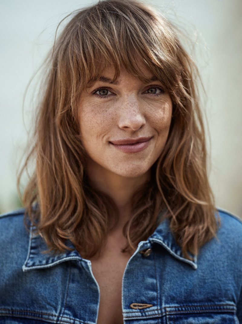 Shoulder-length shag haircut with choppy layers and bangs