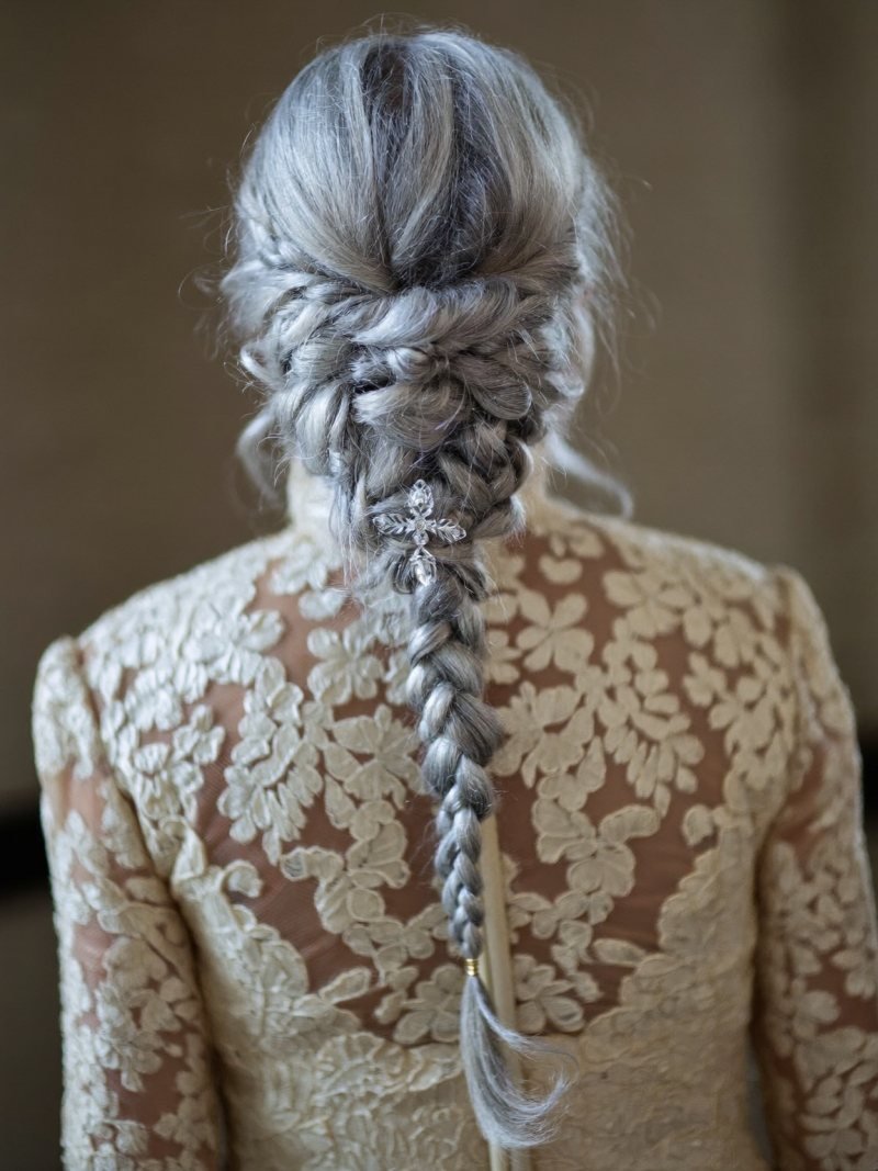 Silver blonde hair in an updo woven from loose braids