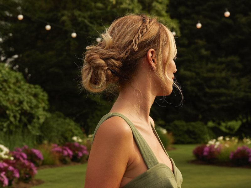 Wedding guest hairstyles: a low textured bun with soft face-framing strands